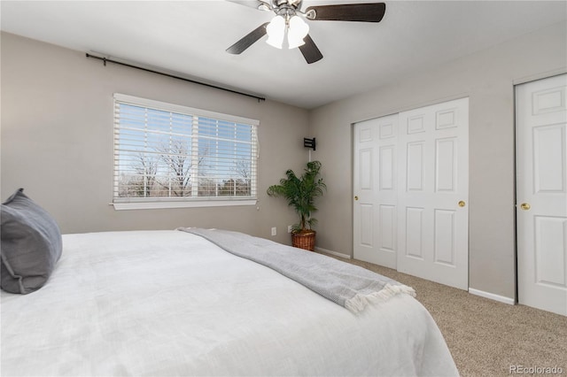 carpeted bedroom with baseboards and ceiling fan