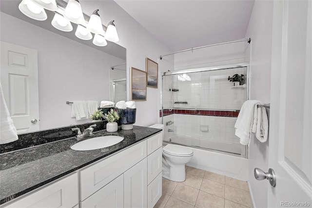 full bathroom featuring tile patterned flooring, vanity, bath / shower combo with glass door, and toilet