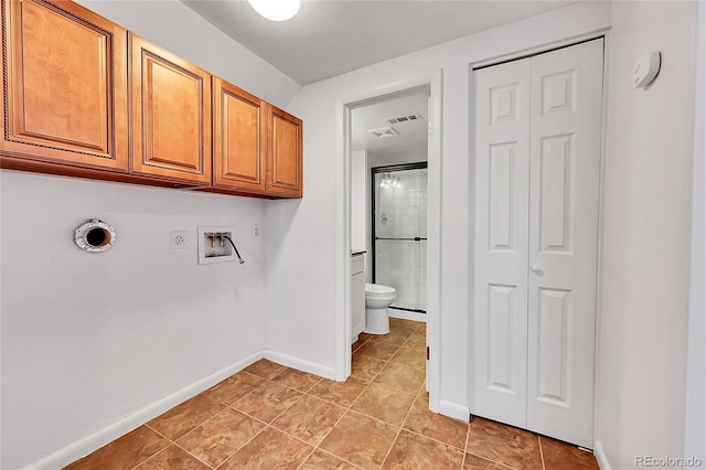 clothes washing area with cabinets, light tile patterned floors, and hookup for a washing machine