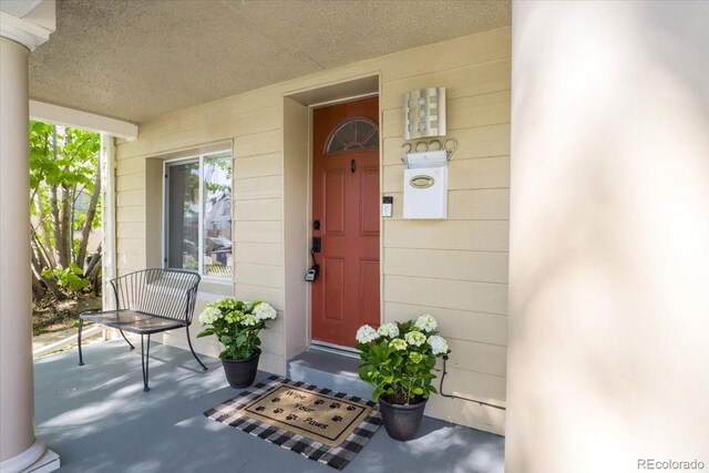 3929 Shoshone St, Denver, CO 80211 - doorway to property featuring covered porch