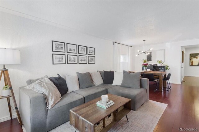 3929 Shoshone St, Denver, CO 80211 - living room featuring a chandelier, wood-type flooring, and baseboards