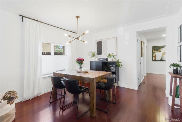 3929 Shoshone St, Denver, CO 80211 - dining space featuring a chandelier, dark wood-type flooring, and baseboards