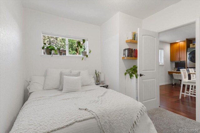 3929 Shoshone St, Denver, CO 80211 - bedroom featuring stacked washer / dryer and wood finished floors