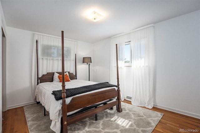 bedroom with baseboards and wood finished floors