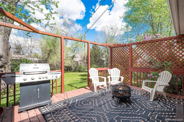 exterior space with a deck and an outdoor fire pit