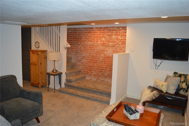 1215 10th Ave, Greeley, CO 80631 - living area with brick wall, carpet flooring, a textured ceiling, stairway, and recessed lighting