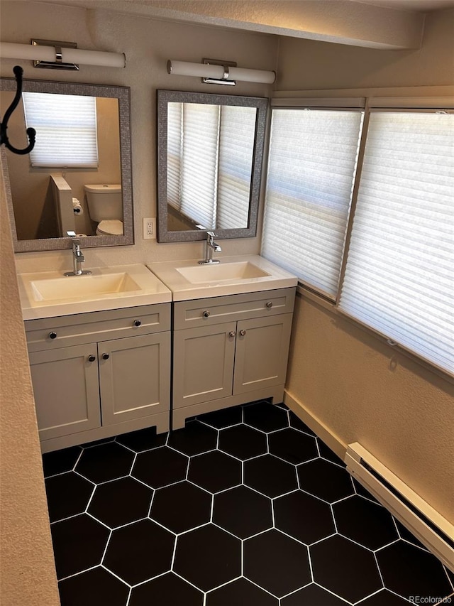 1215 10th Ave, Greeley, CO 80631 - full bathroom with double vanity and a baseboard radiator