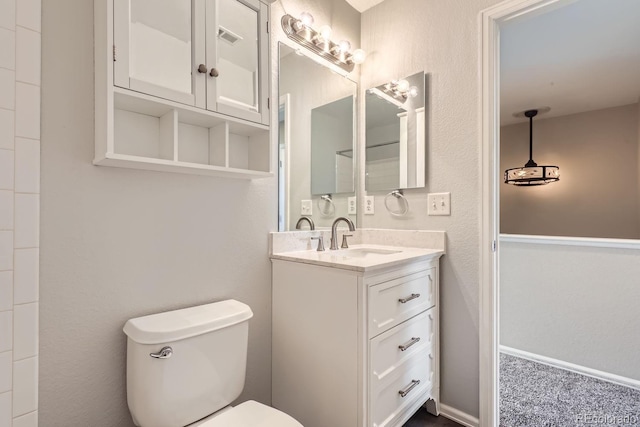 bathroom featuring vanity and toilet