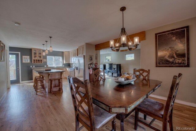 136 W Buckskin Rd, Alma, CO 80420 - dining space with baseboards, an inviting chandelier, and light wood finished floors
