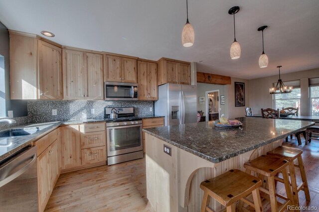 136 W Buckskin Rd, Alma, CO 80420 - kitchen with backsplash, a sink, light wood finished floors, light brown cabinets, and stainless steel appliances