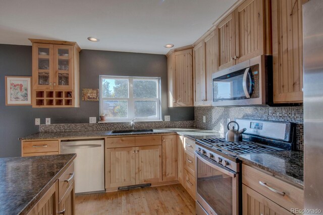 136 W Buckskin Rd, Alma, CO 80420 - kitchen featuring stainless steel appliances, dark stone countertops, a sink, light wood-style floors, and light brown cabinets
