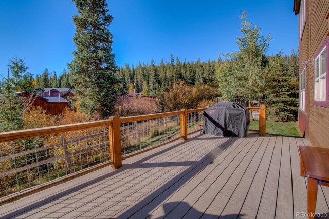 136 W Buckskin Rd, Alma, CO 80420 - wooden terrace featuring grilling area and a wooded view