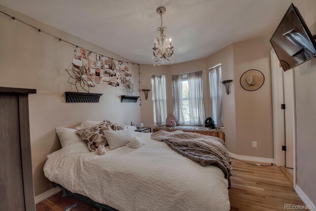 136 W Buckskin Rd, Alma, CO 80420 - bedroom with an inviting chandelier, baseboards, and wood finished floors
