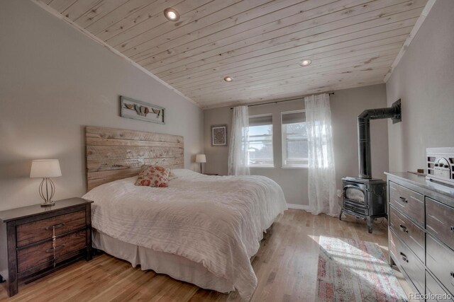 136 W Buckskin Rd, Alma, CO 80420 - bedroom with vaulted ceiling, recessed lighting, a wood stove, wooden ceiling, and light wood-style flooring