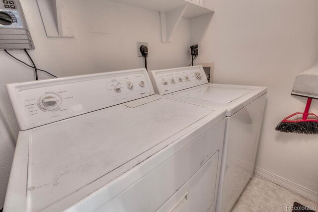 136 W Buckskin Rd, Alma, CO 80420 - clothes washing area featuring light tile patterned floors, washer and clothes dryer, baseboards, and laundry area