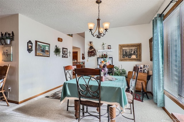 carpeted dining space featuring a textured ceiling and an inviting chandelier