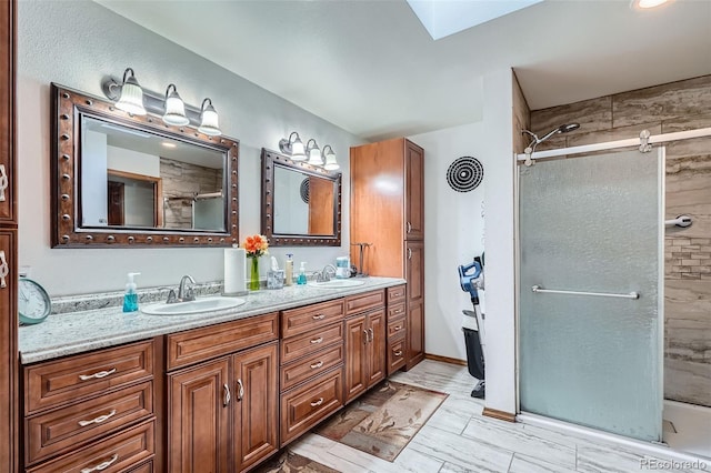 bathroom with vanity, a skylight, and walk in shower