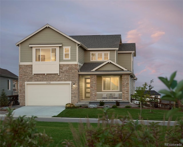 view of front of property with an attached garage, a porch, concrete driveway, and a yard