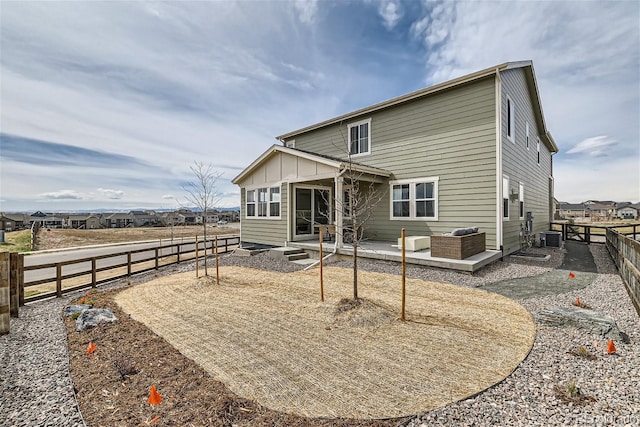 back of property with cooling unit, a fenced backyard, and a patio