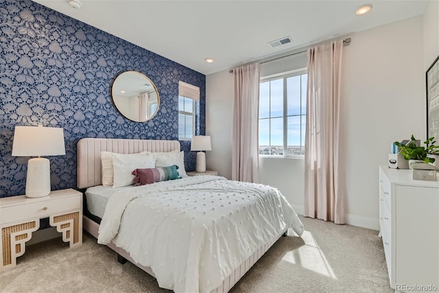 bedroom with recessed lighting, light colored carpet, visible vents, baseboards, and wallpapered walls