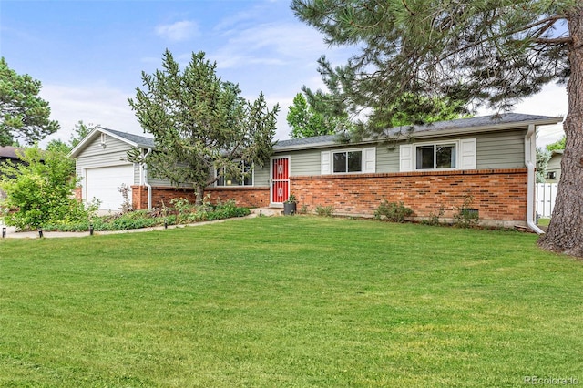 ranch-style home featuring a garage and a front lawn