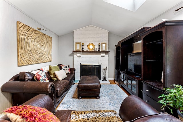 living room with vaulted ceiling, a brick fireplace, hardwood / wood-style floors, and brick wall