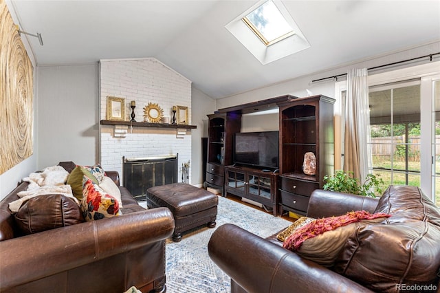 living room featuring brick wall, hardwood / wood-style flooring, lofted ceiling with skylight, and a brick fireplace