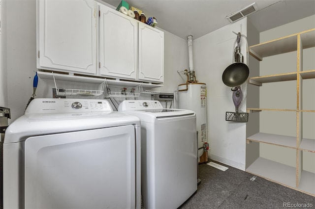 clothes washing area with water heater, cabinets, dark carpet, and washer and clothes dryer