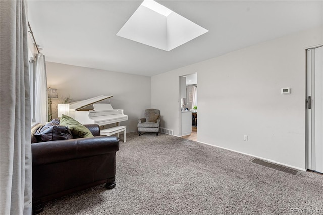 living room featuring a skylight and light colored carpet