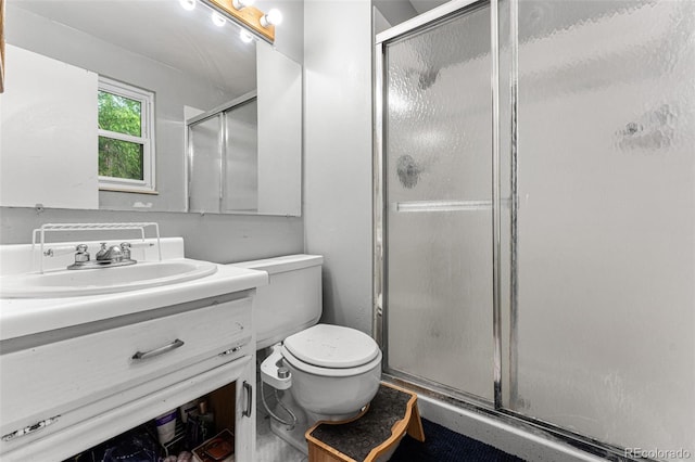 bathroom with an enclosed shower, vanity, and toilet