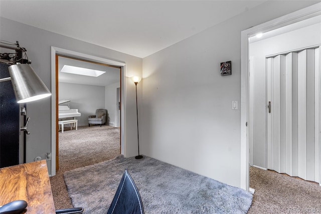 interior space with a skylight and light carpet