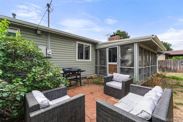 view of patio with a sunroom and outdoor lounge area