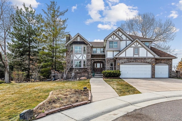 tudor-style house with a chimney, stucco siding, concrete driveway, a garage, and a front lawn