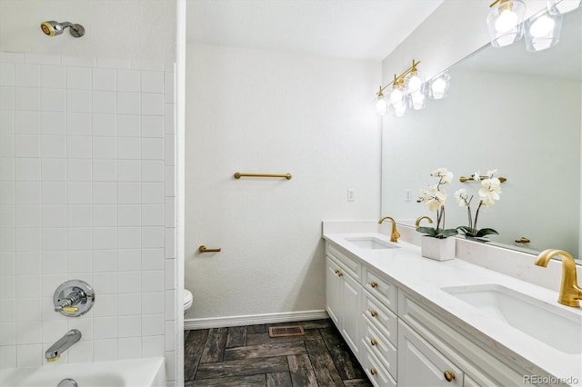 full bathroom featuring double vanity, baseboards, shower / washtub combination, and a sink