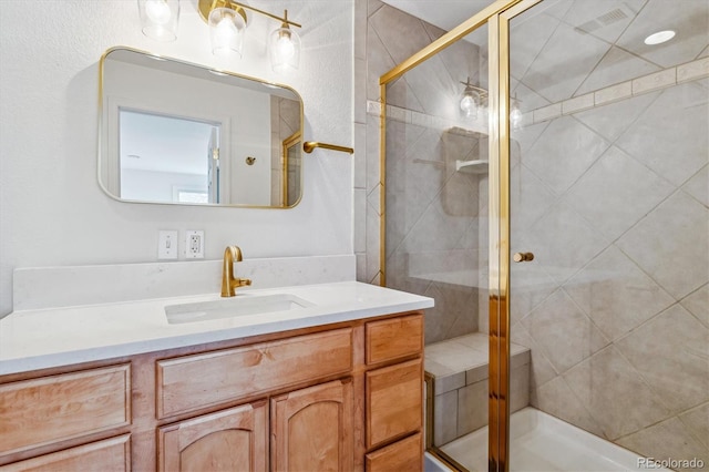 full bath with a shower stall and vanity