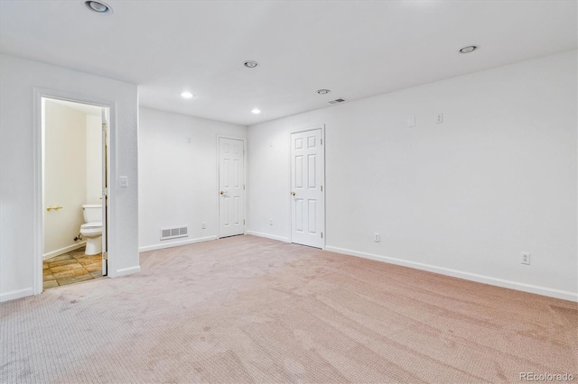 unfurnished bedroom featuring light carpet, baseboards, visible vents, and recessed lighting