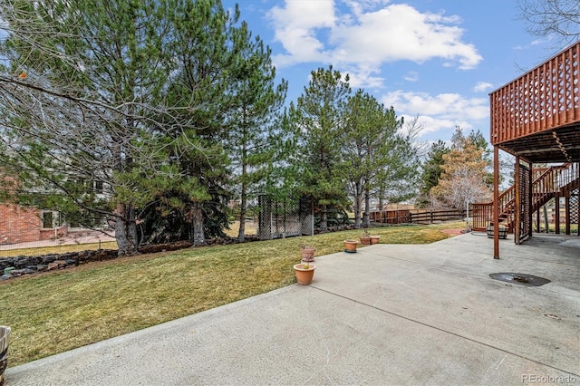 view of yard featuring a patio area, stairway, and a fenced backyard