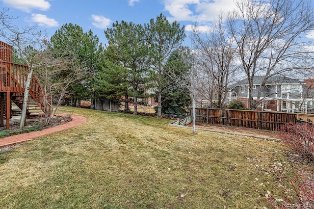 view of yard featuring stairs and fence