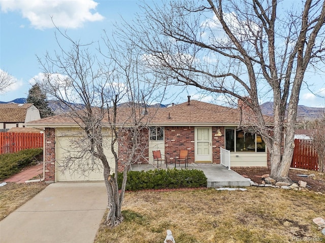 single story home with a front yard and a patio