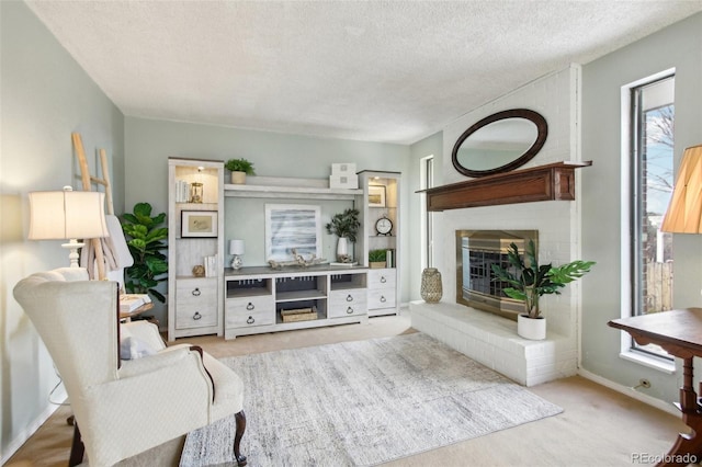 living room featuring a brick fireplace and a textured ceiling