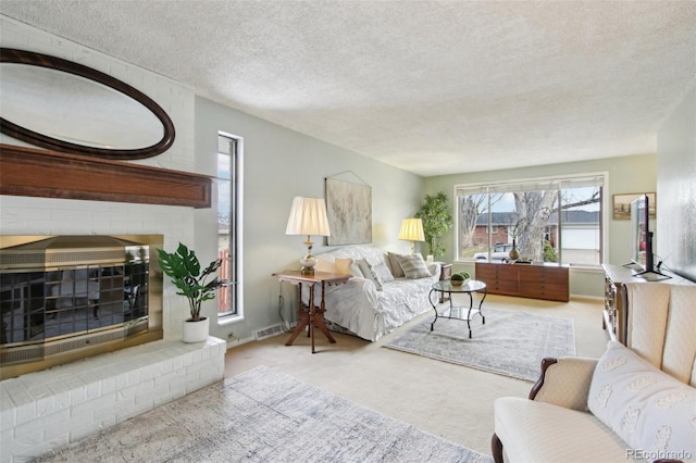 living room with light carpet, a textured ceiling, and a fireplace