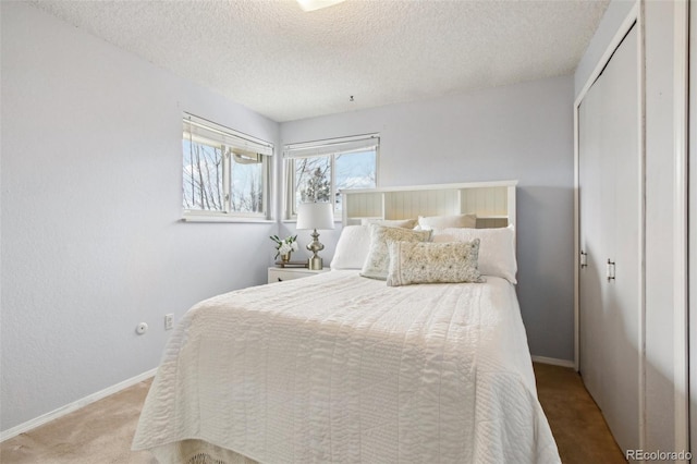 bedroom with light carpet, a closet, and a textured ceiling