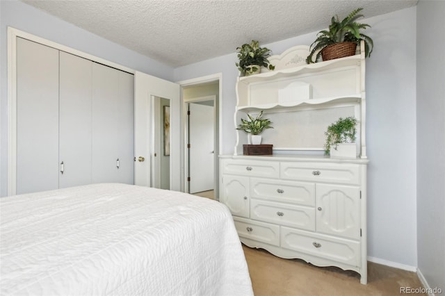 carpeted bedroom featuring a textured ceiling