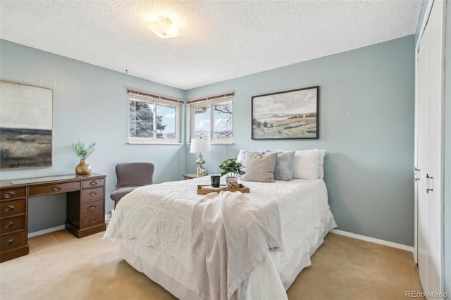 carpeted bedroom featuring a textured ceiling