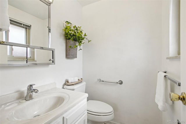 bathroom with toilet and vanity