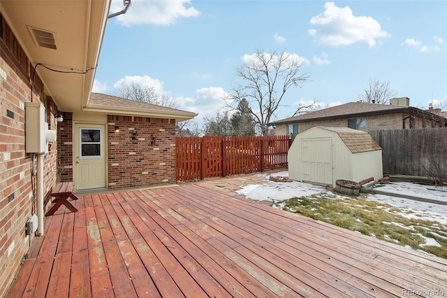 snow covered deck featuring a storage unit