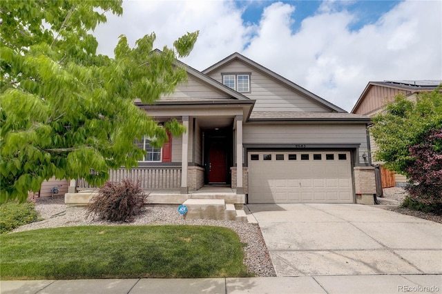 9643 Birch Ln, Thornton, CO 80229 - view of front of property featuring a garage, a porch, concrete driveway, and brick siding