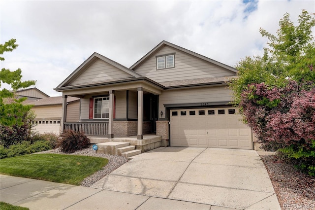 9643 Birch Ln, Thornton, CO 80229 - view of front of home with a porch, a garage, concrete driveway, and brick siding