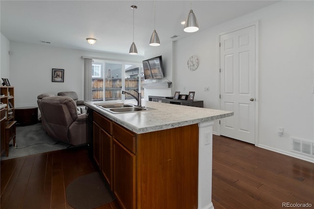 9643 Birch Ln, Thornton, CO 80229 - kitchen featuring a sink, dark wood-style flooring, open floor plan, and light countertops