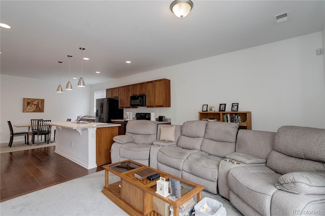 9643 Birch Ln, Thornton, CO 80229 - living area featuring dark wood finished floors and recessed lighting